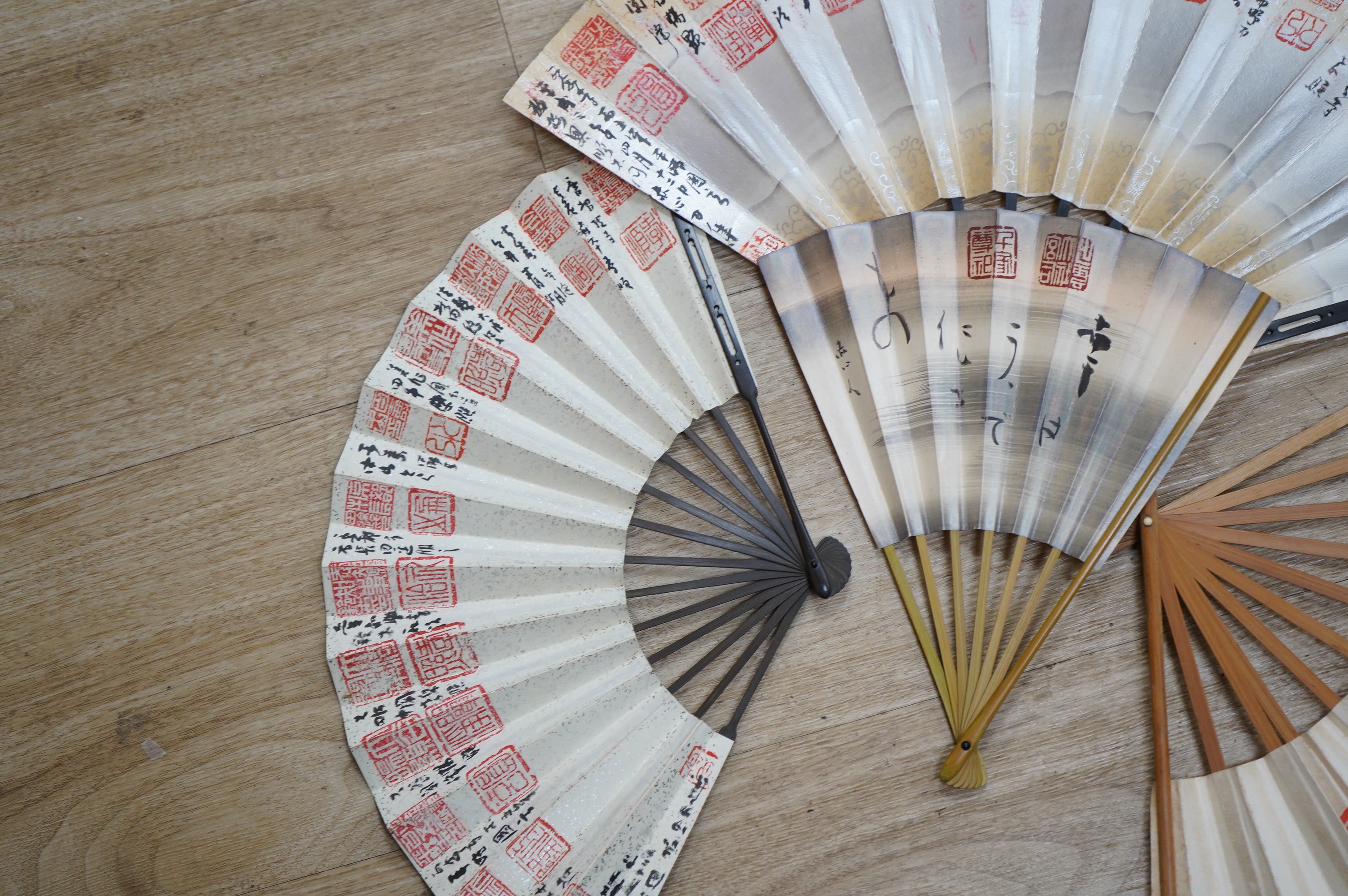 A collection of Japanese 20th century paper leaf fans, one hand painted with koi. Condition - varies, some rips/tears